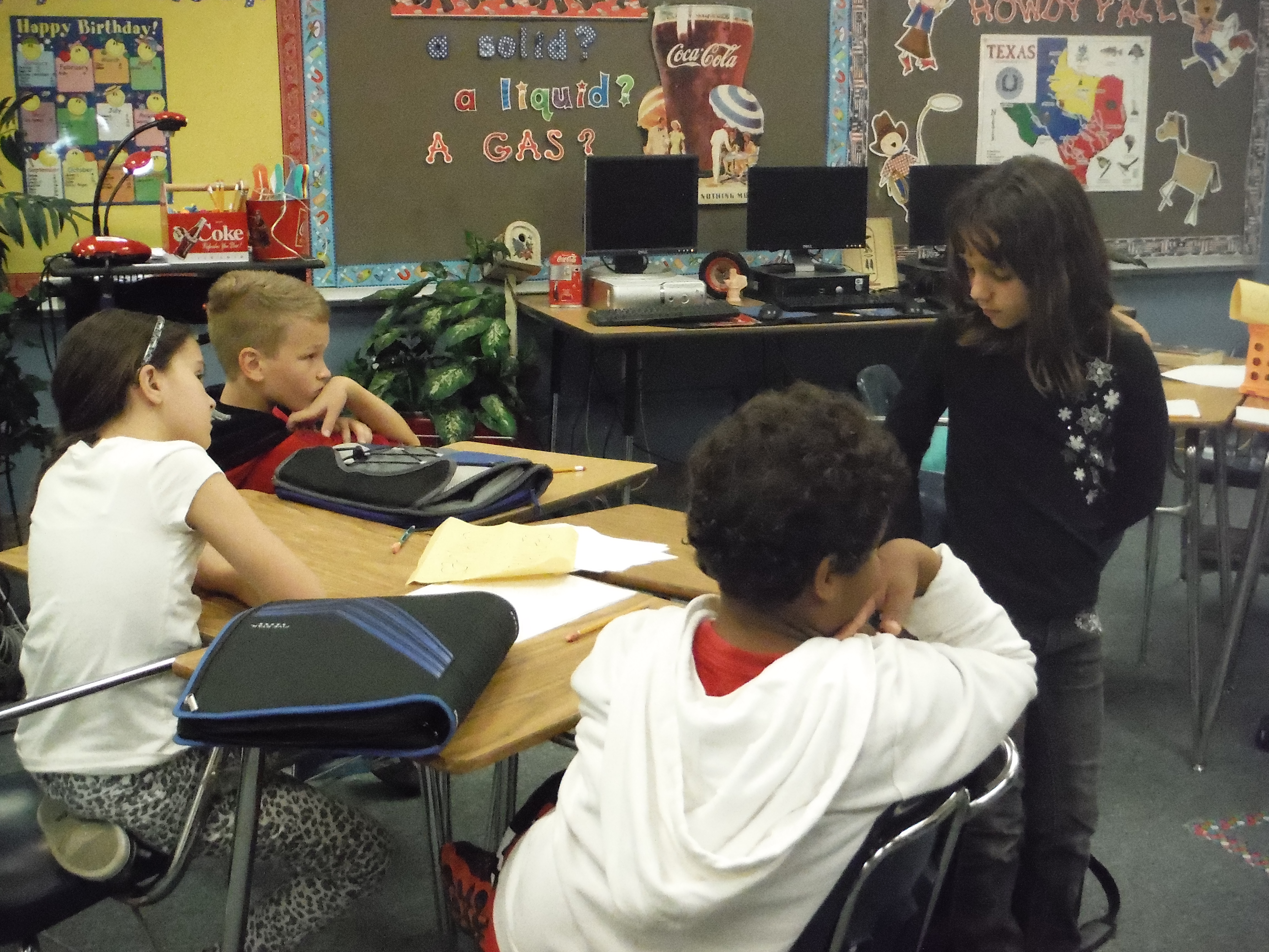 Students work in groups of 4 to retell a story.